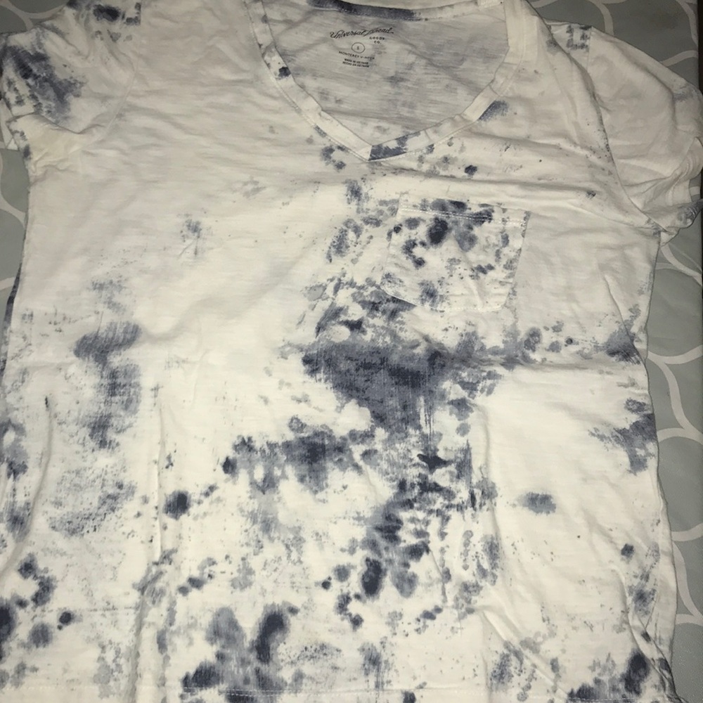 A tie dye blue and white v neck short sleeve shirt